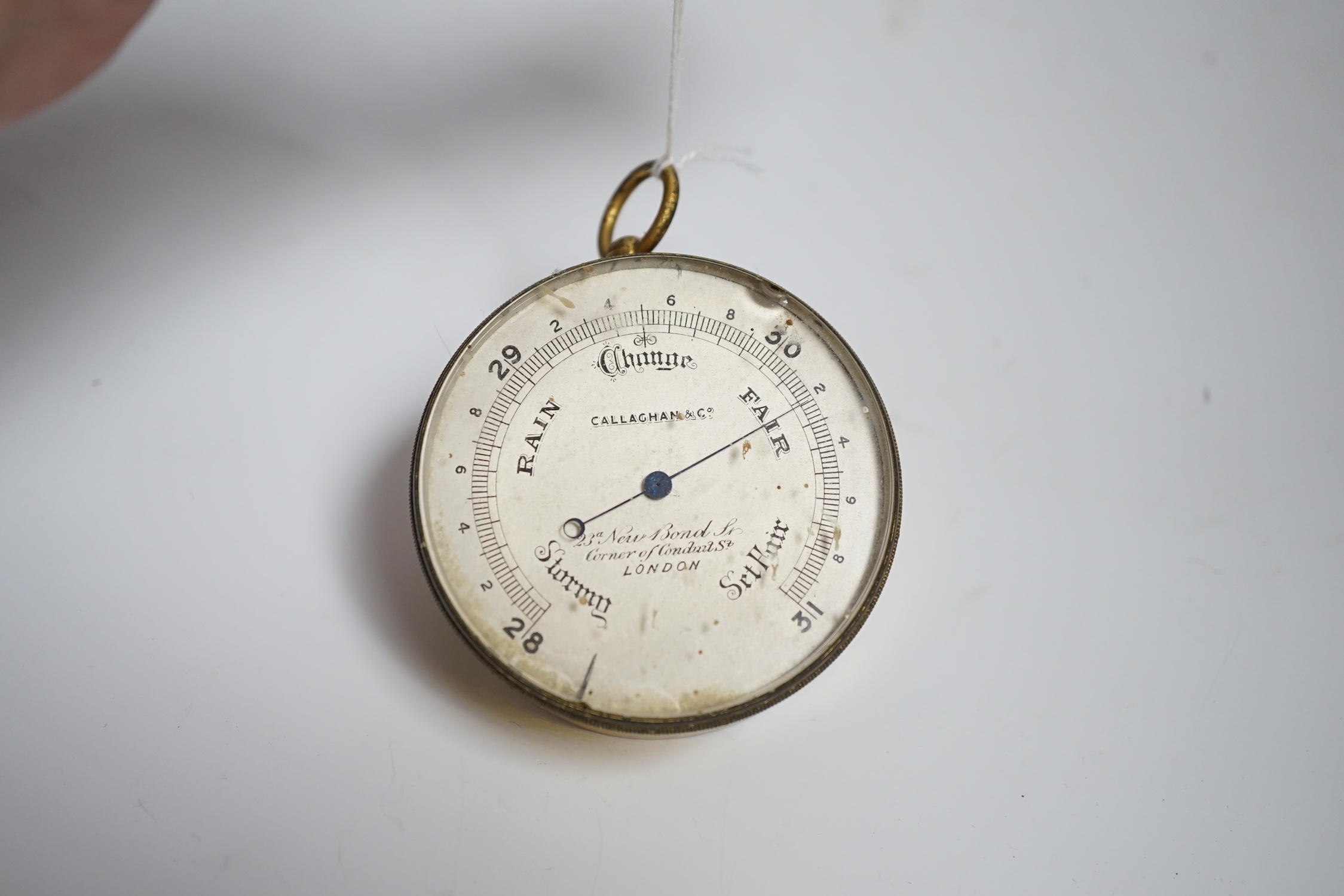 A gilt metal circular pocket barometer by Gallagher and Co., New Bond Street, London (lacks case) and a reproduction solid brass Brunton nautical compass in wooden box